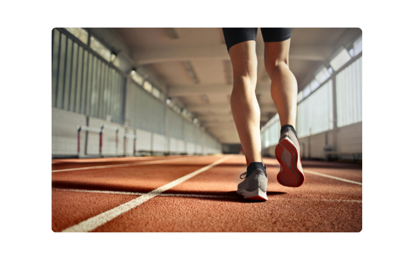 Athlete on an indoor track, a dynamic concept for faceless YouTube channel ideas in sports and fitness content.